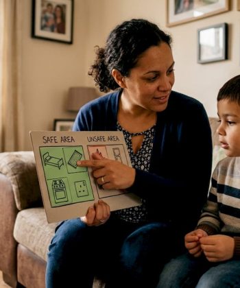 Parent teaching child home safety measures