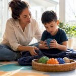 Mother guiding child through sensory play activities