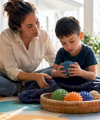 Mother guiding child through sensory play activities