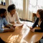 Parents and teacher discussing autism meeting